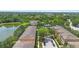 Aerial view showcasing multiple townhome buildings, pond, and surrounding lush landscaping within community at 4297 Regal Town Ln, Lake Mary, FL 32746