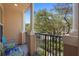 Outdoor covered balcony showing seating and view, with black metal railing and tan columns at 4297 Regal Town Ln, Lake Mary, FL 32746