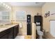 Bathroom with granite double vanity, cabinet storage, and tile floors at 4297 Regal Town Ln, Lake Mary, FL 32746
