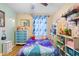 Charming bedroom featuring light hardwood floors, colorful decor, and a bright, cheerful atmosphere at 4297 Regal Town Ln, Lake Mary, FL 32746