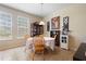 Dining area with a table set for four, with natural light from the large windows at 4297 Regal Town Ln, Lake Mary, FL 32746