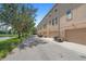 Rear view of townhouse garages along the street, complemented by a tranquil lakeside view at 4297 Regal Town Ln, Lake Mary, FL 32746