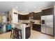 Modern kitchen with granite countertops, stainless steel appliances, and dark brown cabinetry at 4297 Regal Town Ln, Lake Mary, FL 32746