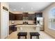 Modern kitchen with granite countertops, stainless steel appliances, and dark brown cabinetry at 4297 Regal Town Ln, Lake Mary, FL 32746