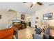 Bright and inviting space featuring tile flooring, cozy sofa and a charming staircase at 4297 Regal Town Ln, Lake Mary, FL 32746