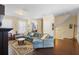 Cozy living room featuring a comfortable sectional couch, hardwood floors, and natural light at 4297 Regal Town Ln, Lake Mary, FL 32746