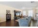 Spacious living room features hardwood flooring, entertainment center and comfortable seating at 4297 Regal Town Ln, Lake Mary, FL 32746