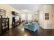 Spacious living room features hardwood flooring, entertainment center and comfortable seating at 4297 Regal Town Ln, Lake Mary, FL 32746