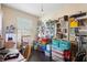 Organized room featuring an easel, shelves filled with books, toys, and a window at 4297 Regal Town Ln, Lake Mary, FL 32746