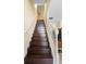 Staircase with stained wood steps and white banister, ascending to the next level at 4297 Regal Town Ln, Lake Mary, FL 32746