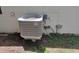 Exterior shot of AC unit on a concrete slab, surrounded by grass and greenery at 4830 Kempston Dr, Orlando, FL 32812