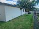 The property features a spacious, grassy backyard and fencing for privacy at 4830 Kempston Dr, Orlando, FL 32812