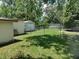 View of backyard, fenced yard, storage shed, and mature trees at 4830 Kempston Dr, Orlando, FL 32812