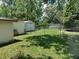 View of backyard, fenced yard, storage shed, and mature trees at 4830 Kempston Dr, Orlando, FL 32812