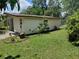 The exterior of the house is surrounded by a green yard and foliage at 4830 Kempston Dr, Orlando, FL 32812