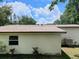 Tan one story home with a new brown roof, set under a partially cloudy blue sky at 4830 Kempston Dr, Orlando, FL 32812