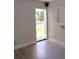 A room with a door leading to the outside, a terrazzo floor, and a white wall at 4830 Kempston Dr, Orlando, FL 32812