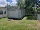 Image of the shed in the backyard with a roll up door at 4830 Kempston Dr, Orlando, FL 32812