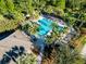 Aerial view of a community pool surrounded by palm trees at 518 Briarbrook Way, Deland, FL 32724