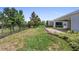 Well-maintained backyard with green grass, landscaping, and iron fence at 518 Briarbrook Way, Deland, FL 32724