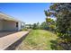 Green backyard features a paver patio, landscape beds, and privacy fence at 518 Briarbrook Way, Deland, FL 32724