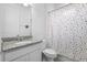 Bathroom featuring a white vanity, granite counter, and a fun polka dot shower curtain at 518 Briarbrook Way, Deland, FL 32724