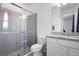 Modern bathroom featuring a tiled walk-in shower and granite countertop vanity at 518 Briarbrook Way, Deland, FL 32724