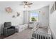 Well-lit bedroom includes two cribs, a window, carpet and a comfortable recliner chair at 518 Briarbrook Way, Deland, FL 32724