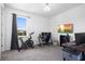 Bedroom featuring a desk setup, TV and an exercise bicycle next to a window at 518 Briarbrook Way, Deland, FL 32724