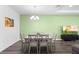 Light and bright dining room with an eye-catching light fixture, hard surface flooring, and an accent wall at 518 Briarbrook Way, Deland, FL 32724