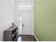 Bright entryway has hard surface floors, white walls, storage, and a craftsman style front door with sidelight at 518 Briarbrook Way, Deland, FL 32724