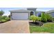 Charming single-Gathering home features a two-car garage, landscaped yard, and a brick driveway at 518 Briarbrook Way, Deland, FL 32724