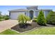 Charming single-Gathering home features a two-car garage, landscaped yard, and a brick driveway at 518 Briarbrook Way, Deland, FL 32724