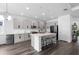 Modern kitchen featuring stainless steel appliances, a large island with seating, and light gray cabinetry at 518 Briarbrook Way, Deland, FL 32724