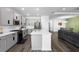 Open-concept kitchen features stainless steel appliances and a large island with stone countertops at 518 Briarbrook Way, Deland, FL 32724