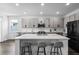 Modern kitchen featuring stainless steel appliances, a large island with seating, and light gray cabinetry at 518 Briarbrook Way, Deland, FL 32724