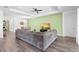 Open-concept living room boasts a coffered ceiling, recessed lighting, hard surface floors, and an accent wall at 518 Briarbrook Way, Deland, FL 32724