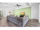 Bright and airy living room featuring modern furnishings, a tray ceiling, and a large sectional sofa at 518 Briarbrook Way, Deland, FL 32724