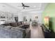 Spacious living room with modern furnishings open to the kitchen and dining area and tray ceilings at 518 Briarbrook Way, Deland, FL 32724