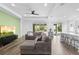 Bright living room features modern ceiling fan, recessed lighting, wood floors, and sliding glass doors to the backyard at 518 Briarbrook Way, Deland, FL 32724