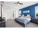 A spacious main bedroom features a blue accent wall, ceiling fan and plush carpeting at 518 Briarbrook Way, Deland, FL 32724