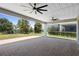 Large covered patio with dual ceiling fans overlooking the fenced-in yard at 518 Briarbrook Way, Deland, FL 32724