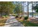 Scenic community sidewalk near a pond with mature trees and landscaping at 518 Briarbrook Way, Deland, FL 32724