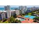 Overhead shot of the community pool and tennis courts, with condo buildings and beach visible at 5300 S Atlantic Ave # 12-403, New Smyrna Beach, FL 32169