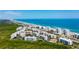 Expansive aerial view of oceanfront condo community with private beach access and lush landscaping at 5300 S Atlantic Ave # 12-403, New Smyrna Beach, FL 32169