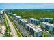 An aerial view of condos with a lush green space and beach access, showcasing prime waterfront real estate at 5300 S Atlantic Ave # 12-403, New Smyrna Beach, FL 32169
