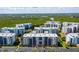 Aerial view of condo community with manicured lawns, lush landscaping, and ample parking at 5300 S Atlantic Ave # 12-403, New Smyrna Beach, FL 32169