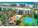 Wide aerial shot showcasing the pool, tennis courts, and community near the beach at 5300 S Atlantic Ave # 12-403, New Smyrna Beach, FL 32169