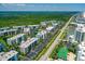 Expansive aerial view of the condo complex, pools, tennis courts and surrounding landscapes at 5300 S Atlantic Ave # 12-403, New Smyrna Beach, FL 32169