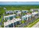 A scenic aerial view of multiple condos, pool, and landscaping, highlighting community amenities at 5300 S Atlantic Ave # 12-403, New Smyrna Beach, FL 32169